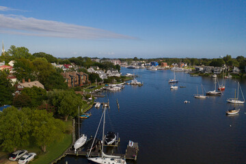 Aerial view of colorful sailboat moorings and docks surrounded by colorful residential rooftops on...