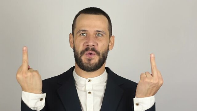 .A Young successful businessman he expresses disgust and shows indecent hand gestures. A Young successful businessman shows indecent hand gestures
