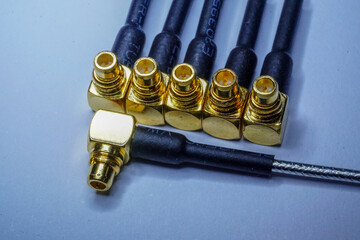 Close-up of gold plated MMCX radio network communications pigtail electronics component