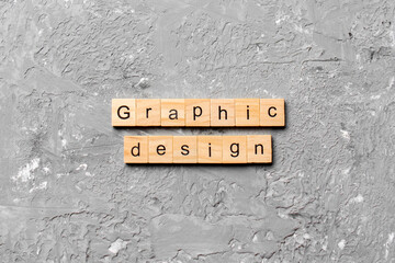 graphic design word written on wood block. graphic design text on cement table for your desing,...