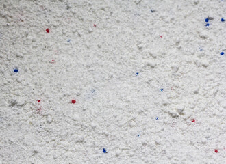 The texture of white washing powder interspersed with granules