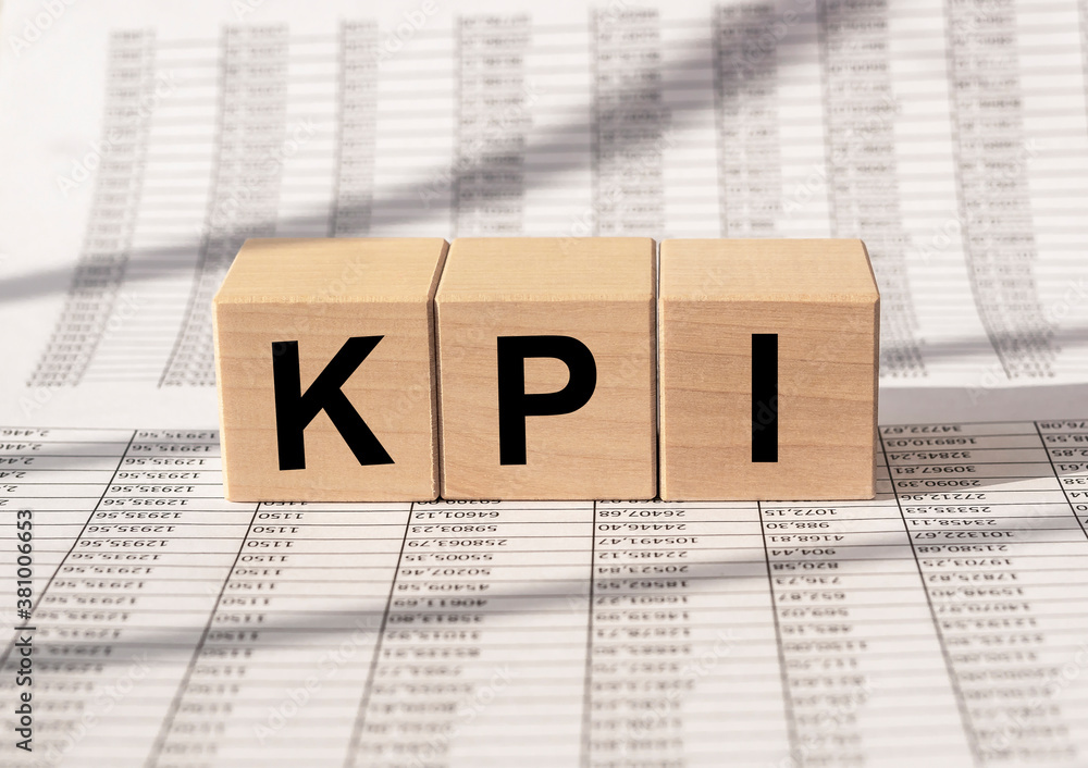 Poster text kpi - key performance indicator - on white table with financial accounting documents digits
