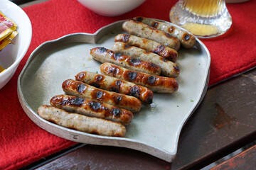 German bratwurst sausages on a heart shaped metal plate