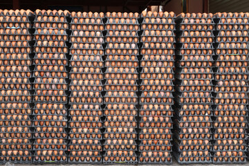 Many packages of eggs in black plastic storage from chicken farm that delivery for sale in the wholesale market