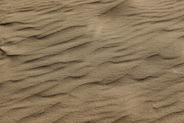 Blurry image of sand pattern. Abstract nature background, beige colors.