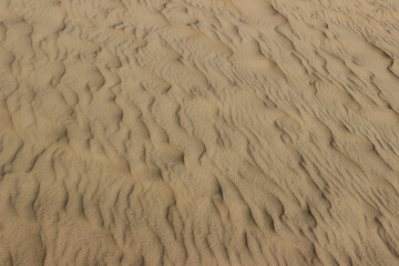 Blurry image of sand pattern. Abstract nature background, beige colors.