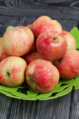 Apples in a vase. On brushed boards, painted black and white.