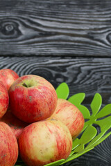 Apples in a vase. On brushed boards, painted black and white.