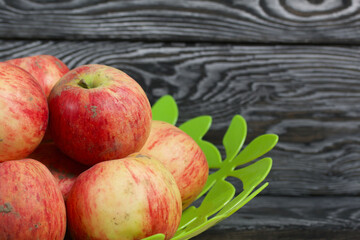 Apples in a vase. On brushed boards, painted black and white.