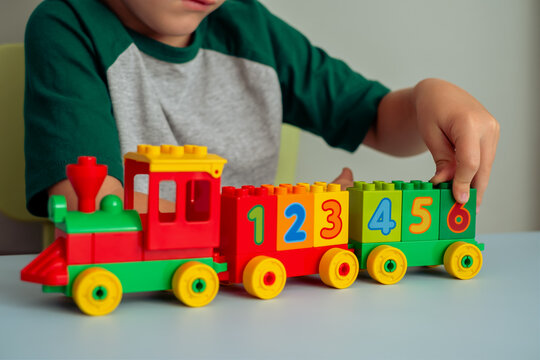  Child playing with a train, blocks of numbers. Educational toys for preschool and kindergarten children.