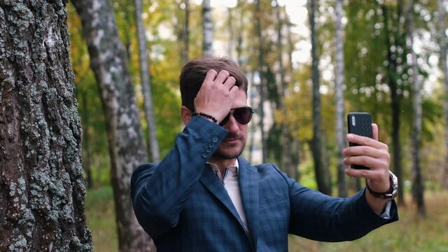 Businessman takes a photo in the Park