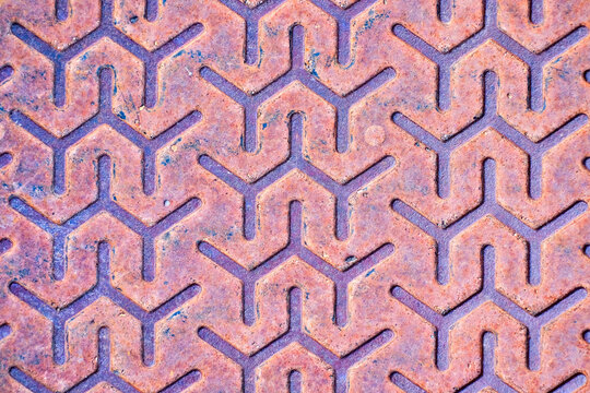 Abstract letter Y pattern decorative design on a rusty metal plate.