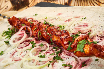 Lula kebab with pita bread on a wooden board