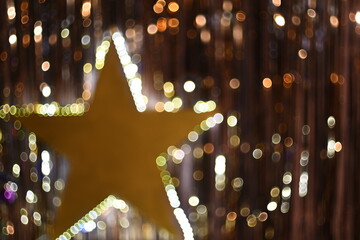 golden background with glowing star and beautiful bokeh