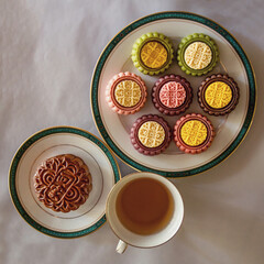Mooncake, Moon cake for Mid-Autumn Festival, traditional festive food on a white background with tea and and the Chinese sign 
