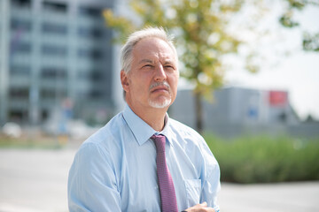 Pensive man walking in a city