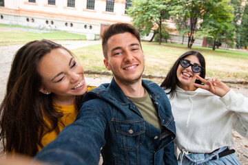 Group of happy friends taking a selfie together