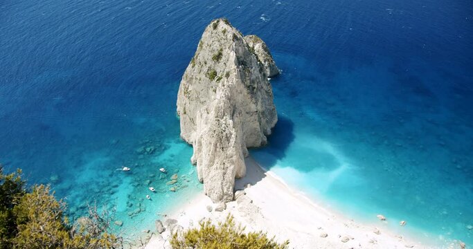 Zakynthos island, Greece. Secluded beach with white rock formation near Keri with blue lagoon, tourist pleasure boats. Top view