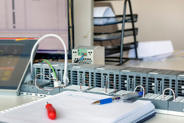 View of the simple programmable logic controller (PLC) on the table in the office. It is an...