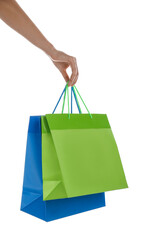 Woman with paper shopping bags on white background, closeup