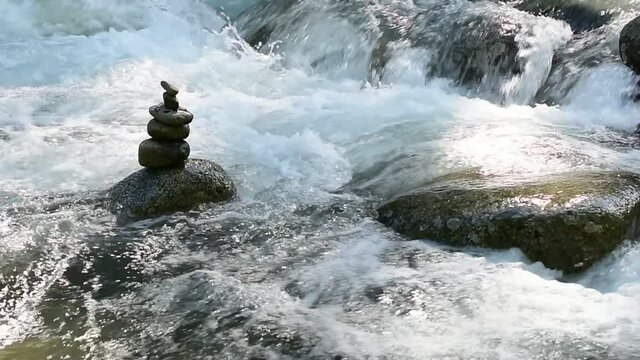 Stacked stones stand as a counterpoint to the power of Alaska's Little Susitna River.