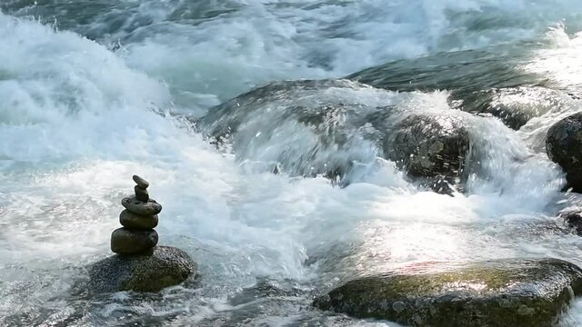 Stacked stones stand as a counterpoint to the power of Alaska's Little Susitna River.