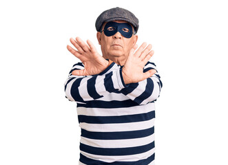 Fototapeta premium Senior handsome man wearing burglar mask and t-shirt rejection expression crossing arms doing negative sign, angry face