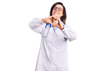 Young beautiful woman wearing doctor stethoscope and glasses smiling in love doing heart symbol shape with hands. romantic concept.