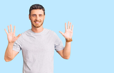 Naklejka premium Handsome young man with bear wearing casual tshirt showing and pointing up with fingers number ten while smiling confident and happy.