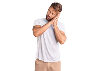 Young caucasian man wearing casual white tshirt sleeping tired dreaming and posing with hands together while smiling with closed eyes.