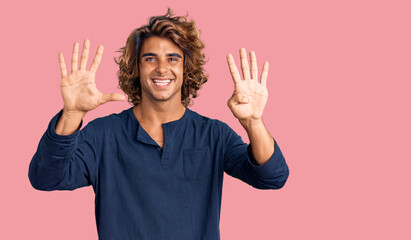 Young hispanic man wearing casual clothes showing and pointing up with fingers number nine while smiling confident and happy.