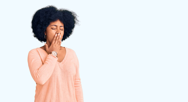 Young african american girl wearing casual clothes bored yawning tired covering mouth with hand. restless and sleepiness.