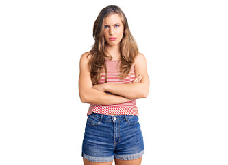 Beautiful caucasian young woman wearing casual clothes skeptic and nervous, disapproving expression on face with crossed arms. negative person.