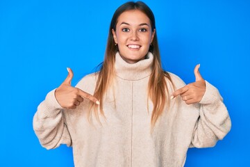 Beautiful caucasian woman wearing wool winter sweater looking confident with smile on face,...
