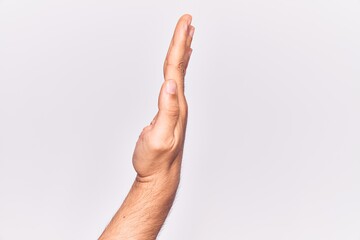 Close up of hand of young caucasian man over isolated background showing the side of stretched hand, pushing and doing stop gesture