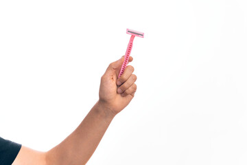 Hand of caucasian young man holding pink disposible razor over isolated white background