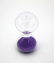 Glass hourglass on white background