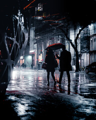 silhouette of couple walking in the city with umbrella while raining at night