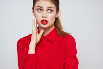 portrait of a woman with red lips in a shirt on a light background cropped view model makeup hairstyle