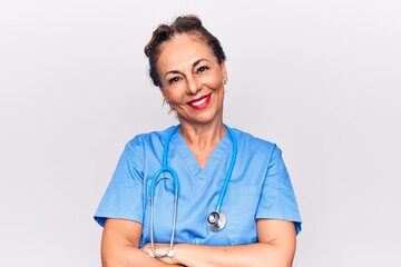 Middle age brunette nurse woman wearing uniform and stethoscope over white background happy face smiling with crossed arms looking at the camera. Positive person.