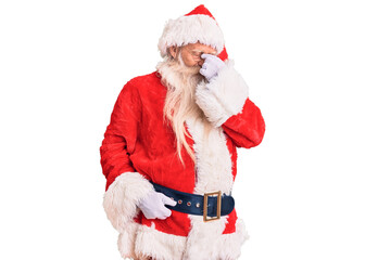 Old senior man with grey hair and long beard wearing traditional santa claus costume tired rubbing nose and eyes feeling fatigue and headache. stress and frustration concept.
