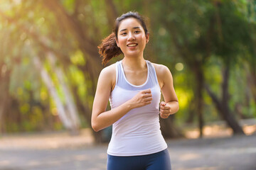 Fototapeta premium Young woman running in a park
