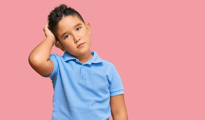 Little boy hispanic kid wearing casual clothes confuse and wondering about question. uncertain with...