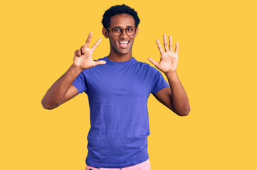 African handsome man wearing casual clothes and glasses showing and pointing up with fingers number eight while smiling confident and happy.