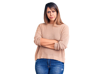 Young beautiful woman wearing casual sweater skeptic and nervous, disapproving expression on face...