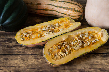 Three types of winter squash on wooden background, fall harvest still life composition 