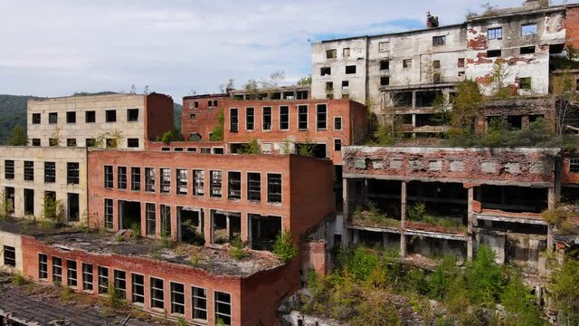 View from above. Khrustalnensky mining and processing plant. The camera flies past the destroyed buildings of a tin mining plant in Russia.
