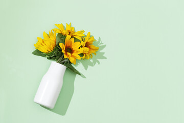 Yellow sunflowers in white vase , view from above. Bright autumn blooming flowers with copy space.