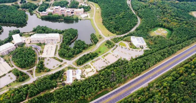 Flight over Research Triangle Park in Durham, NC shows National Institute of Environmental Health Sciences, Environmental Protection Agency, and US EPA National Computer Center beside Discovery Lake n