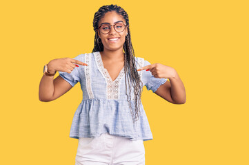 Young african american woman with braids wearing casual summer clothes and glasses looking...